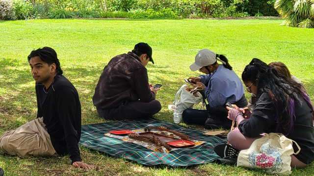 youths on smartphone outdoors